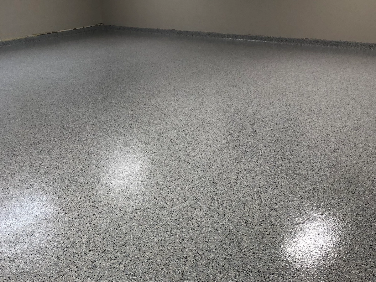 Large basement room finished with a custom flake epoxy floor