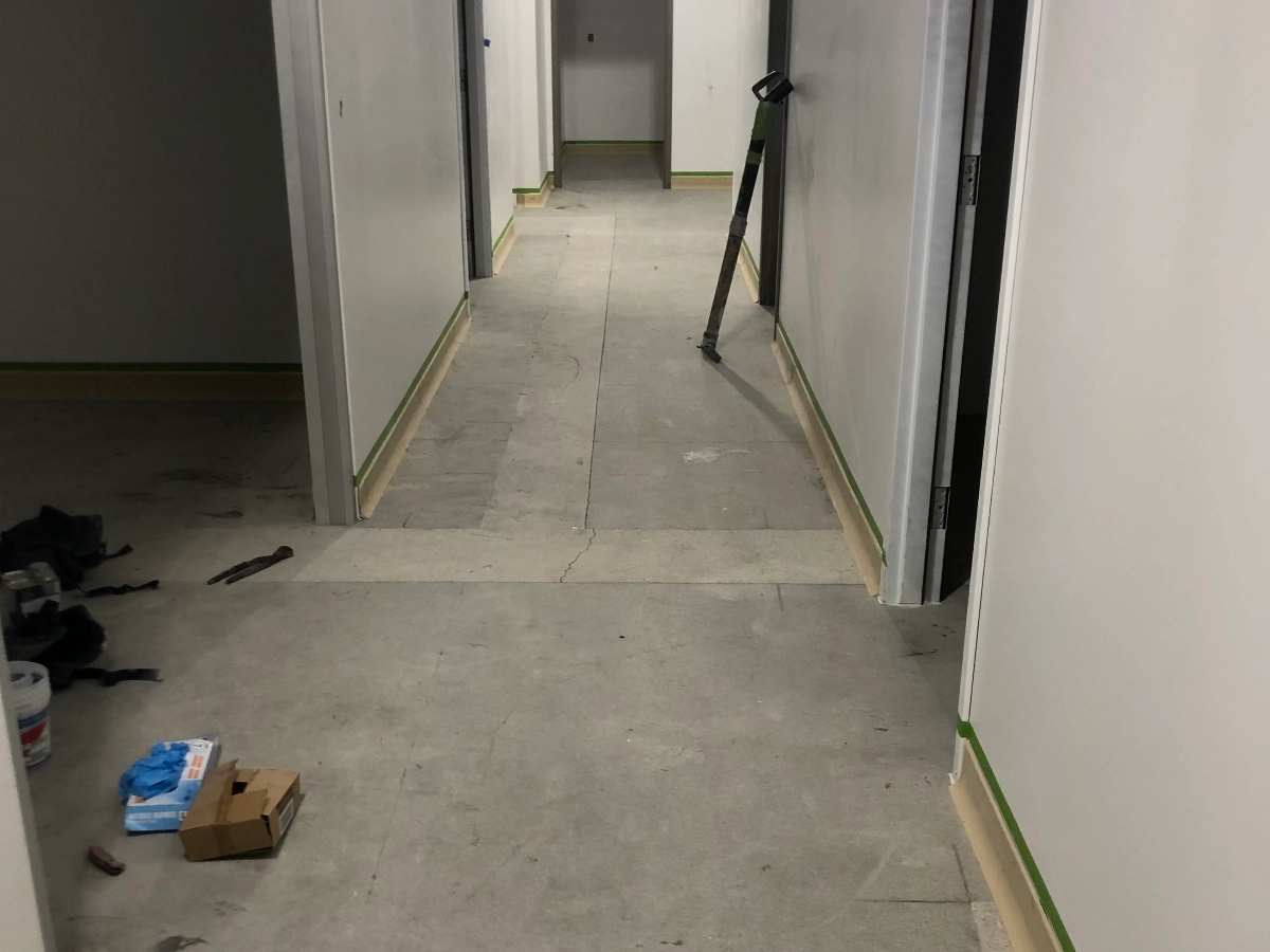 Alleyway and side rooms with bare concrete floor