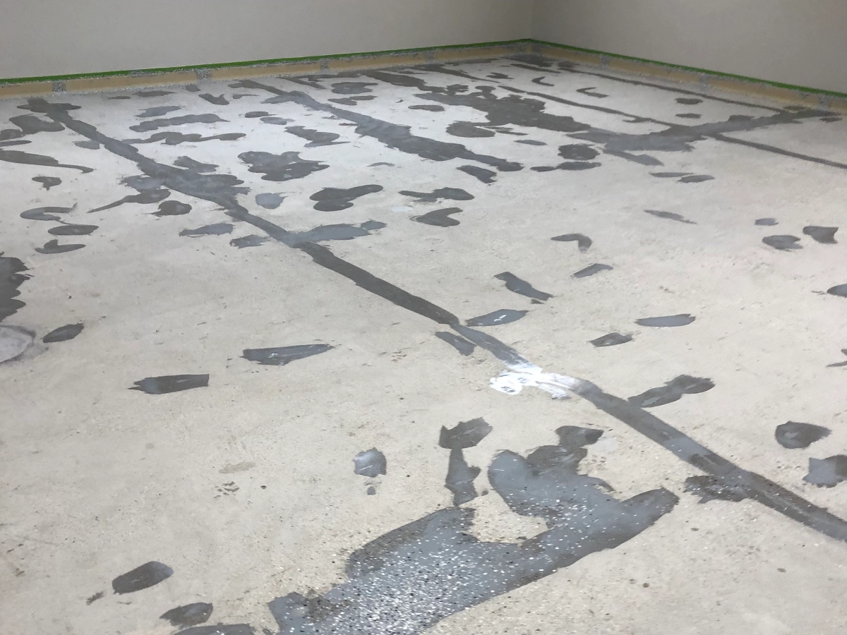 Large basement room with concrete floor prepped by Rhino Epoxy